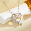Exquisite silver heart pendant necklace featuring pink enamel and sparkling cubic zirconia. - Pink Hollow Heart Necklace / Silver