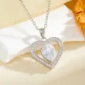 Close-up detail of a delicate heart-shaped zirconia pendant necklace with sparkling stone. - Teardrop Heart Style (T014) / Silver White Rhinestone