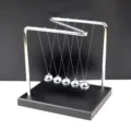 Detailed view of the metal Newton's cradle balance balls desk toy for office and home decor. - Medium Z-Shaped Wooden Base Impact Ball / Silver