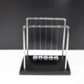 Metal Newton's cradle balance balls physics science toy desktop office decor detail view - Large Square Wooden Base Impact Ball / Silver