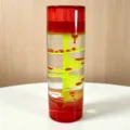 Detail shot of the creative liquid motion bubbler toy with a vibrant red and yellow spiral design. - Red
