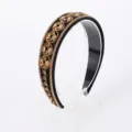 Exquisite baroque style rhinestone headband detail showcasing sparkling amber crystals and beads. - Gold