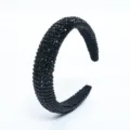 Detailed close-up view of the elegant black rhinestone full-wrap headband accessory. - Black