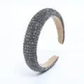 Detailed view of the dark grey rhinestone headband, sparkling crystal luxury hair accessory. - Gray