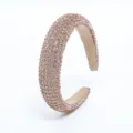 Detailed view of champagne rhinestone padded headband, elegant sparkling hair accessory for women. - Champagne