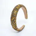 Close-up of the sparkling glitter sequin star headband, showing fine texture and star details. - Gold