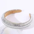 Close-up detail of luxurious rhinestone padded headband sparkling crystal hair accessory. - Silver