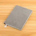 Grey business notebook featuring soft faux leather cover and a metal pendant decoration. - Gray