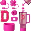 Detail shot of pink silicone tumbler accessories set with straw covers, cup boot, and letter D. - Letter D
