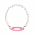 Pearl chain cup strap detail view, elegant white beads with gold clasps and pink silicone ring. - Pink