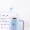 Stainless steel tumbler with cute blue heart straw topper and floral pattern cup sleeve. - Straw Cap / Blue