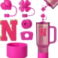 Pink Stanley tumbler accessories set with heart straw covers, silicone boot, and letter N patch. - Letter N