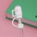 Cute mini cup shape silicone straw cover with pink daisy design, dustproof tumbler accessory. - White
