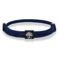 Close-up shot of the dark blue woven Milan rope bracelet with metal charm and black clasp. - Tree of Life Woven Bracelet (Dark Blue) / Dark Blue