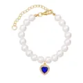 Detailed view of pearl pet necklace with sparkling blue heart pendant and gold extension chain. - Sapphire Blue Zirconia Heart Necklace - 8