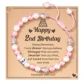Detailed view of handmade pink and white pearl 2nd birthday bracelet with number 2 bead card. - Happy 2nd Birthday