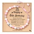 Detailed view of the 6th birthday beaded bracelet with pink and white pearls and number 6. - Happy 6th Birthday