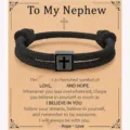 Detailed close-up of the black woven rope bracelet featuring a stainless steel cross charm. - Nephew - 13