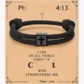 Detailed view of the handmade black Milan rope bracelet featuring a stainless steel cross charm. - 4:13-12