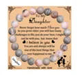 Detailed view of the daughter beaded bracelet with heart charm and sentimental message card. - Pink Zebra + daughter Card