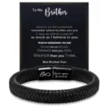Detailed view of a black braided leather bracelet with a stainless steel magnetic clasp. - To My Brother