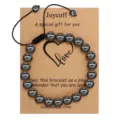 Black hematite stone bead bracelet with adjustable woven cord on special message gift card. - Hematite