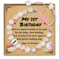 Baby first birthday beaded bracelet detail with pink pearls and custom card packaging. - My 1st Birthday