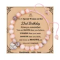 Detailed view of the beaded birthday bracelet with card, featuring pink stones and heart charm. - 23rd Birthday + 8mm Pink Zebra Jasper