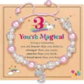 Detailed view of kids pink beaded bracelet with unicorn charm and number three card. - You're - 1