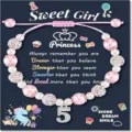 Detailed shot of kids beaded bracelet with unicorn pendant, pink pearls and rhinestones. - Sweet-2
