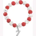 Close-up detail of red and white rhinestone beaded sports bracelet with number 7 charm. - Number 7 - 12