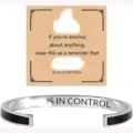 Detailed view of the stainless steel inspirational cuff bracelet with engraved encouraging quote. - Black Steel - CONTROL