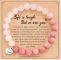 Close-up detail of natural stone beaded bracelet with inspirational card and heart pendant. - Style 17