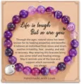 Detailed view of the purple agate beaded bracelet with a silver heart charm on display card. - Style 19