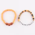 Stackable clay bead bracelets featuring basketball charms and letter beads, orange and black. - 24-Piece Basketball Set (12 Pieces Each)