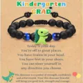 Kids graduation beaded bracelet with green dinosaur charm and matte black beads for kindergarten. - Kindergarten Dinosaur
