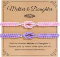 Detailed close-up view of the mother daughter woven bracelet set with pink and purple knots. - Pink + Purple - 8