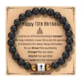 Pulsera de obsidiana natural y ojo de tigre mate con cruz de acero detalle de producto - Estilo 13 Cumpleaños