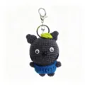 Handmade crochet plush doll keychain, dark grey cute cat bag pendant with blue overalls. - Little Black Creature Keychain with Green Leaf