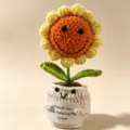 Closeup crochet sunflower potted plant, handmade knitted flower toy detail with cute smiling face. - Blush Sunflowers