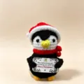 Handcrafted crochet Christmas penguin doll ornament with Santa hat and greeting card gift toy. - Black Hat Penguins
