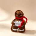 Handmade crochet gingerbread man doll with red scarf, cute Christmas knit toy ornament for holiday. - Christmas Gingerbread Man