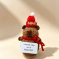 Handmade crochet Christmas animal doll ornament with red hat and scarf, cute holiday gift. - Christmas Capybara