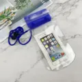 Clear waterproof phone pouch detail shot, featuring blue sealing clip and lanyard for beach use. - Blue