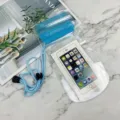 Transparent waterproof phone pouch with secure blue seal and lanyard for travel use. - Purple
