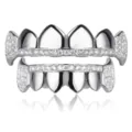 Close up detail of silver hip hop grillz teeth with sparkling zircon stones and vampire fangs design. - Milky White