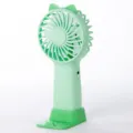 Green handheld mini fan with cat ear design, USB rechargeable desktop fan with stand. - Green