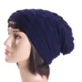 Close-up detail of the knitted slouchy beanie texture, showing soft winter warmth and style. - One Size / Navy Blue