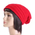 Detailed close-up view of the cozy red knitted slouchy beanie showcasing fine texture. - One Size / Red