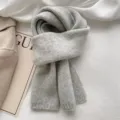 Cozy winter knitted scarf detail, solid gray soft warm fabric, elegant lazy style accessory. - Premium Grey